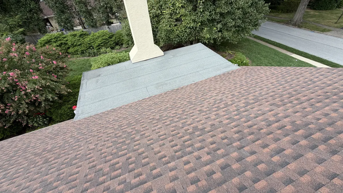 Shingle roof tying into a low-slope flat roof section by LV Roofing & Siding
