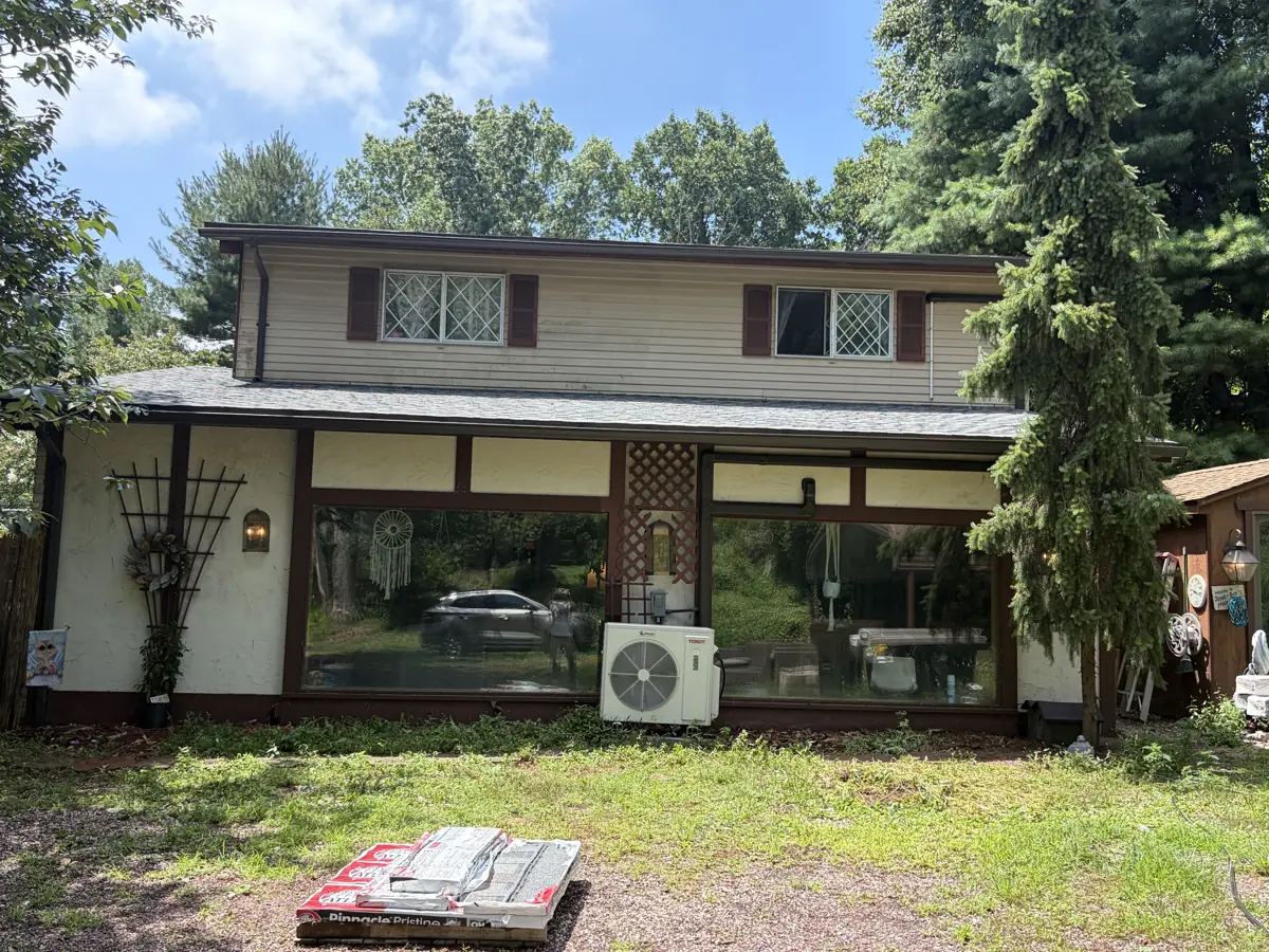 New shingle roof and brown seamless gutters on a two-story home in the Lehigh Valley by LV Roofing & Siding